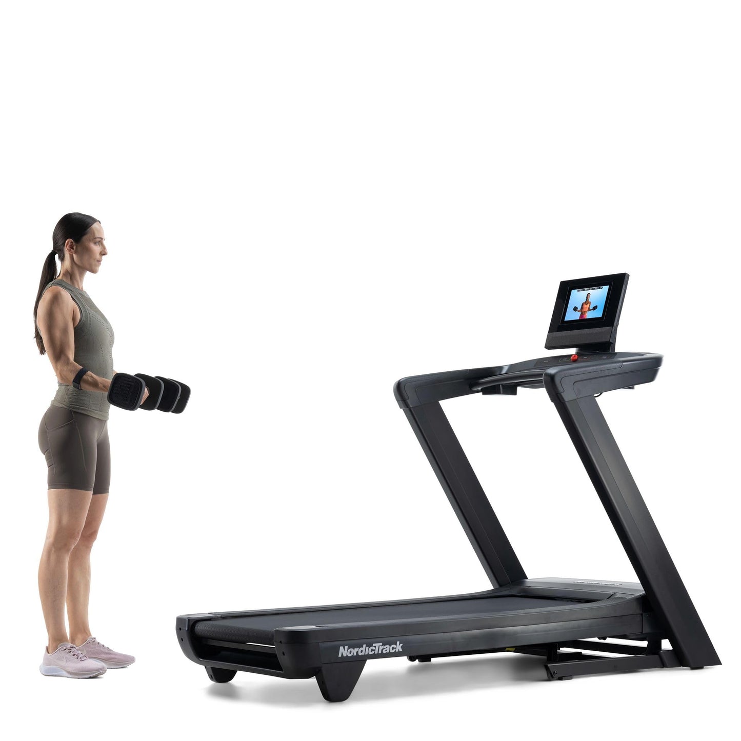 Woman standing next to a treadmill with a screen displaying an app on a white background