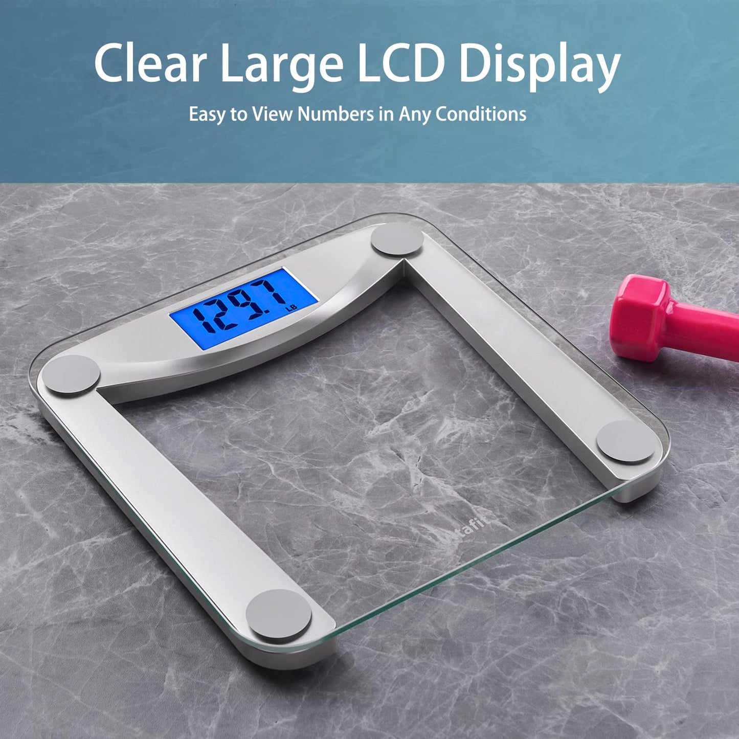 Digital bathroom scale with clear large LCD display on a gray surface, accompanied by a pink dumbbell.
