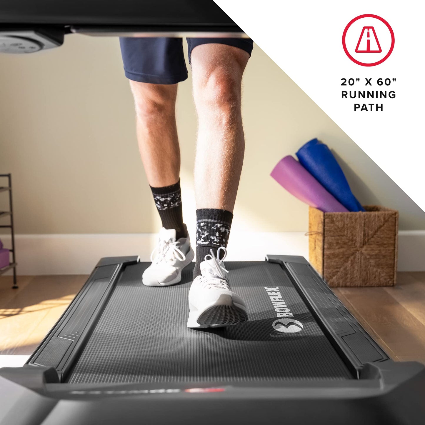Person using a Bowflex treadmill with a running path size displayed.