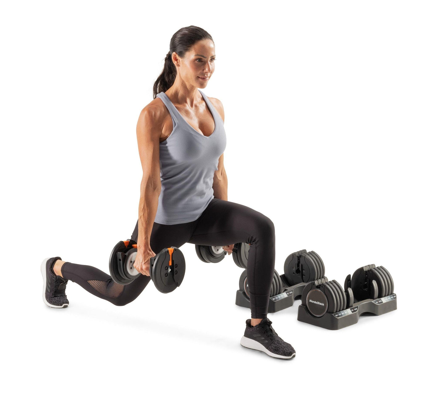 Woman exercising with adjustable dumbbells on a white background