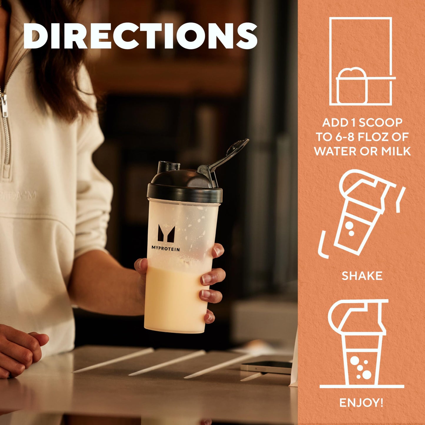 Person holding a protein shake cup with directions on an orange background