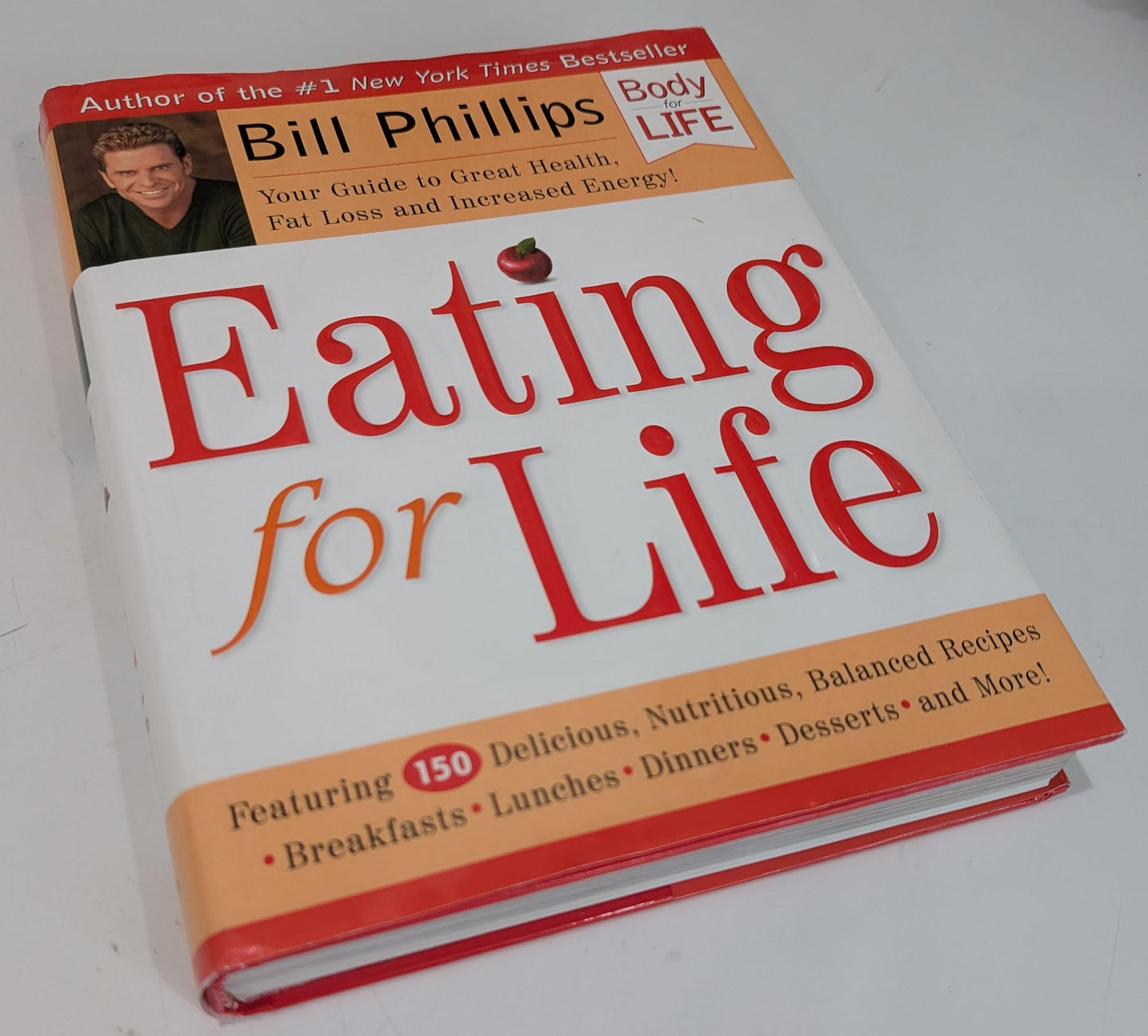 Book titled 'Eating for Life' by Bill Phillips on a white background