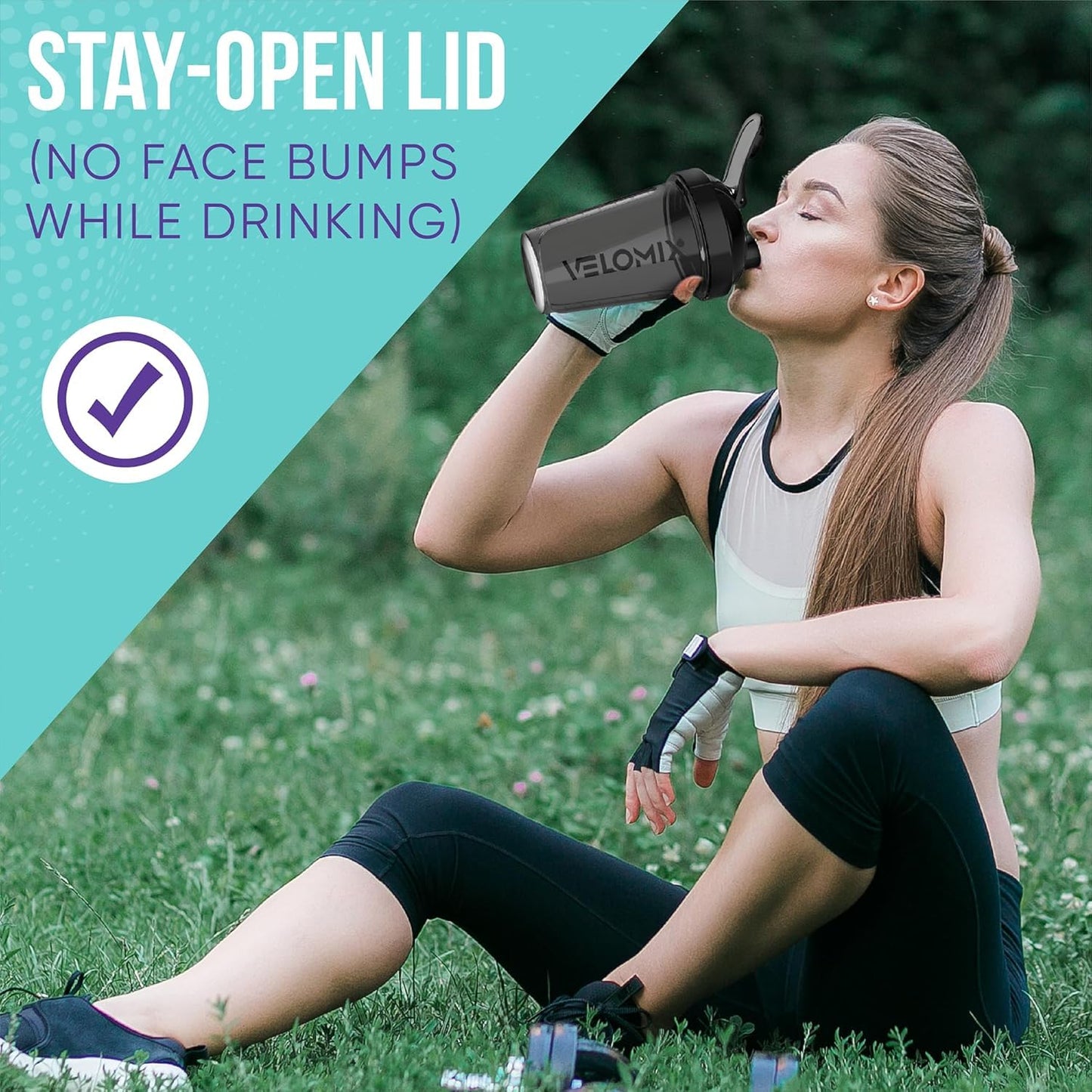 Woman sitting on grass drinking from a black water bottle with text about a 'stay-open lid' feature.