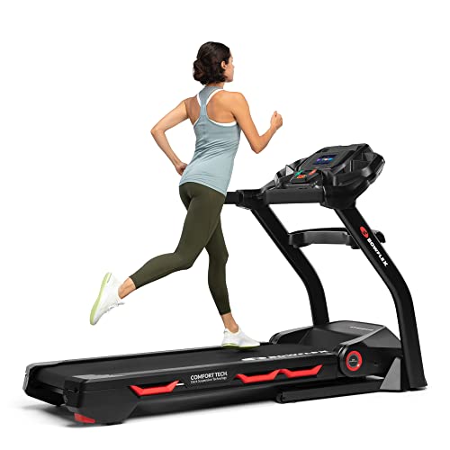 Woman running on a treadmill with a white background