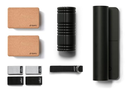 Collection of fitness tools including cork blocks, a roller, and straps on a white background