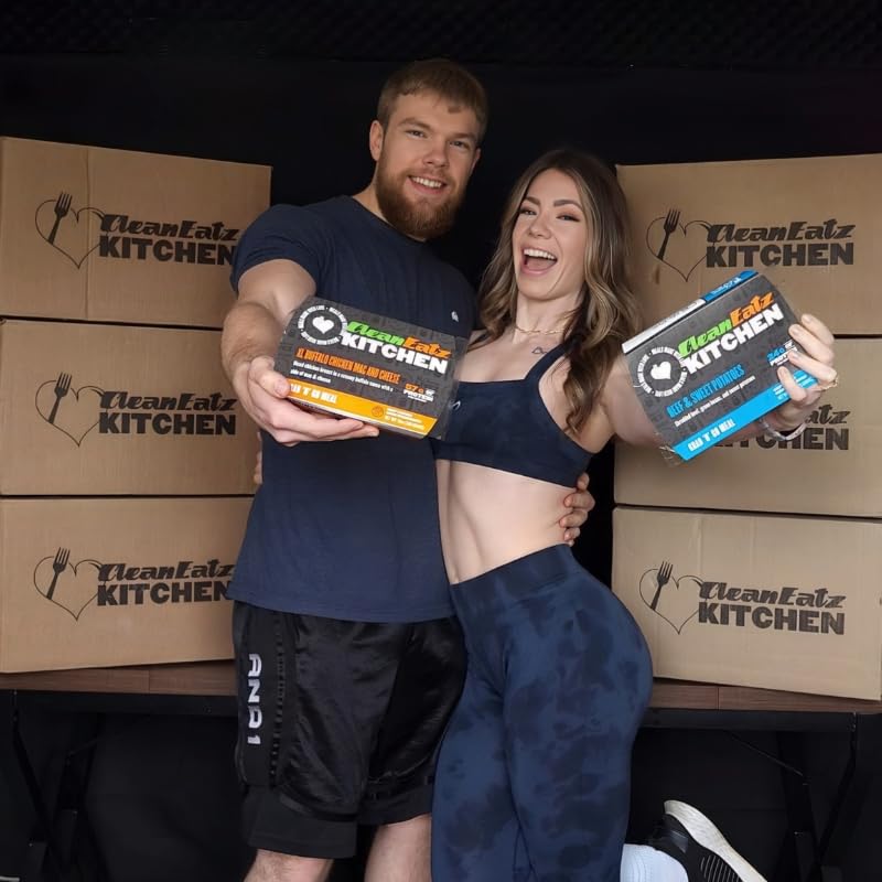 Man and woman holding CleanEatz Kitchen products with boxes in the background