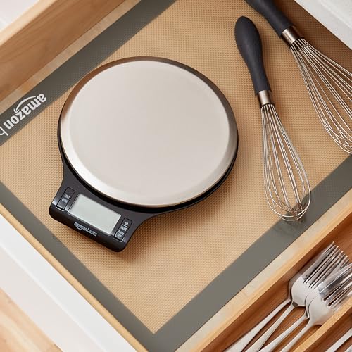 Digital kitchen scale on a wooden surface with utensils