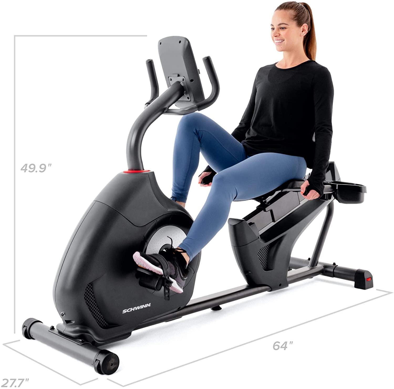 Woman using a Schwinn exercise bike with dimensions displayed