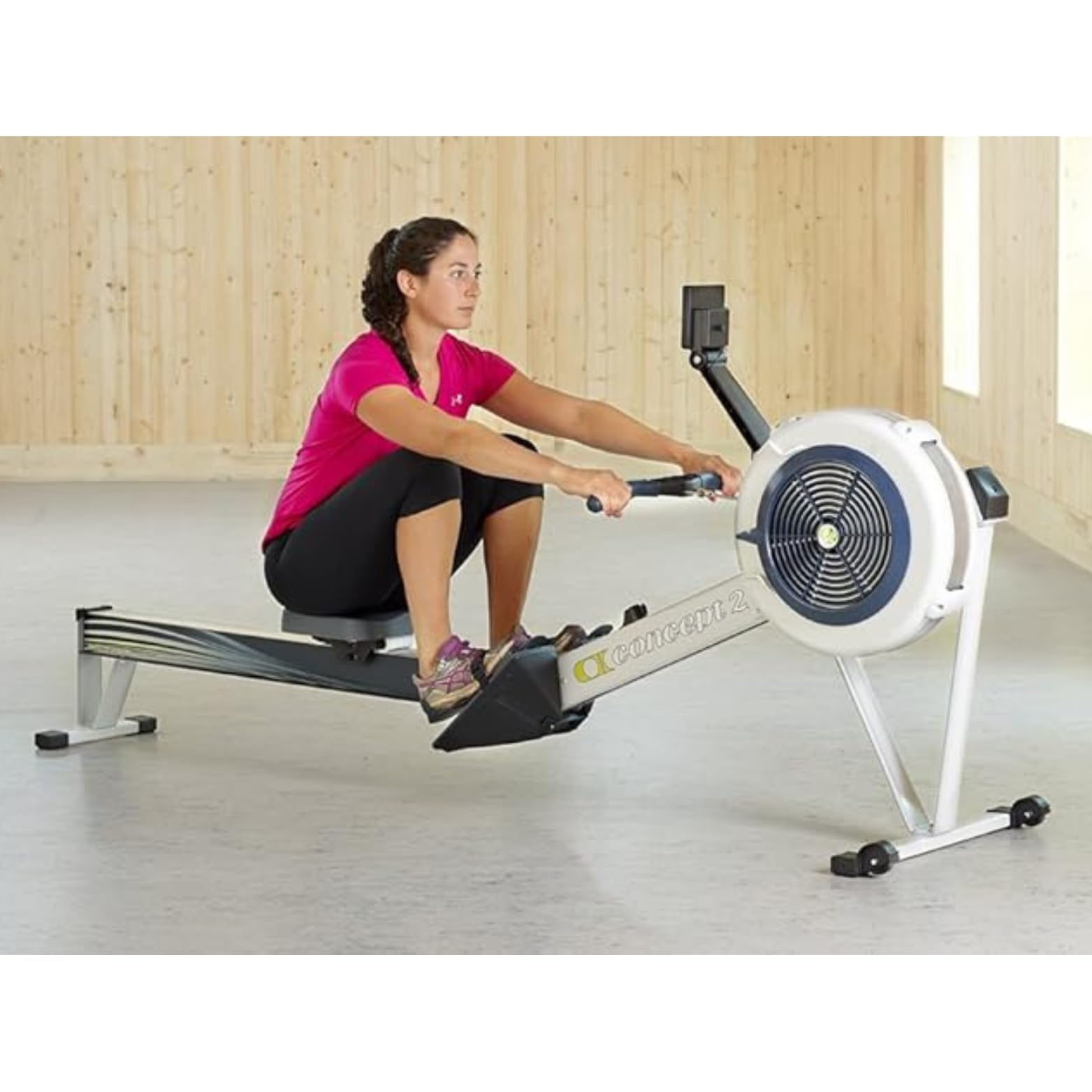 Woman using a rowing machine in a home setting