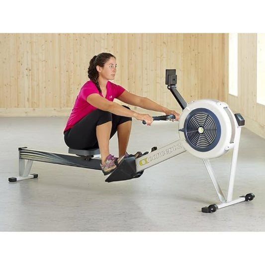 Woman using a rowing machine in a home setting