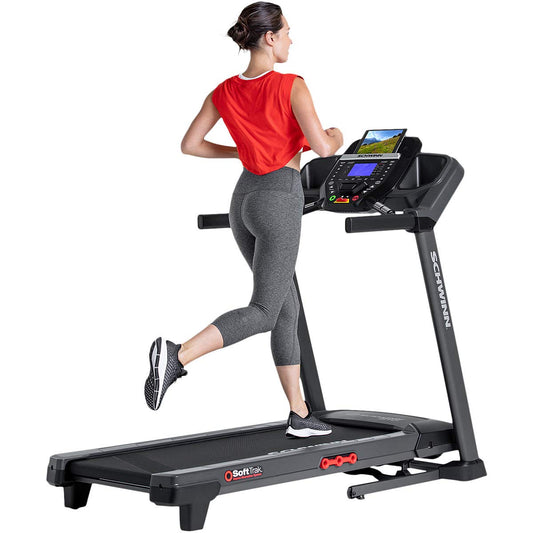 Woman running on a treadmill with a white background