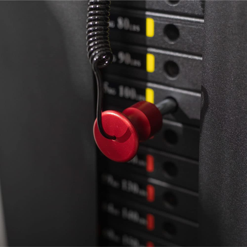 Red earplugs hanging on an audio equalizer with volume knobs.