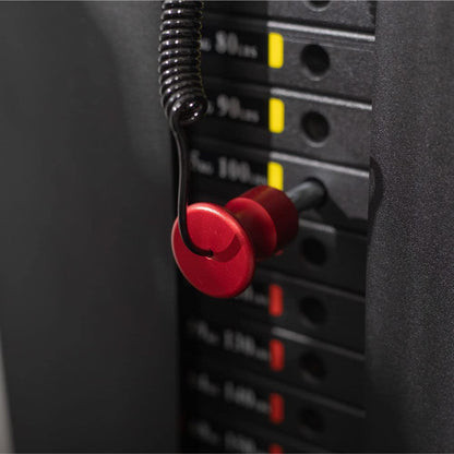 Red earplugs hanging on an audio equalizer with volume knobs.