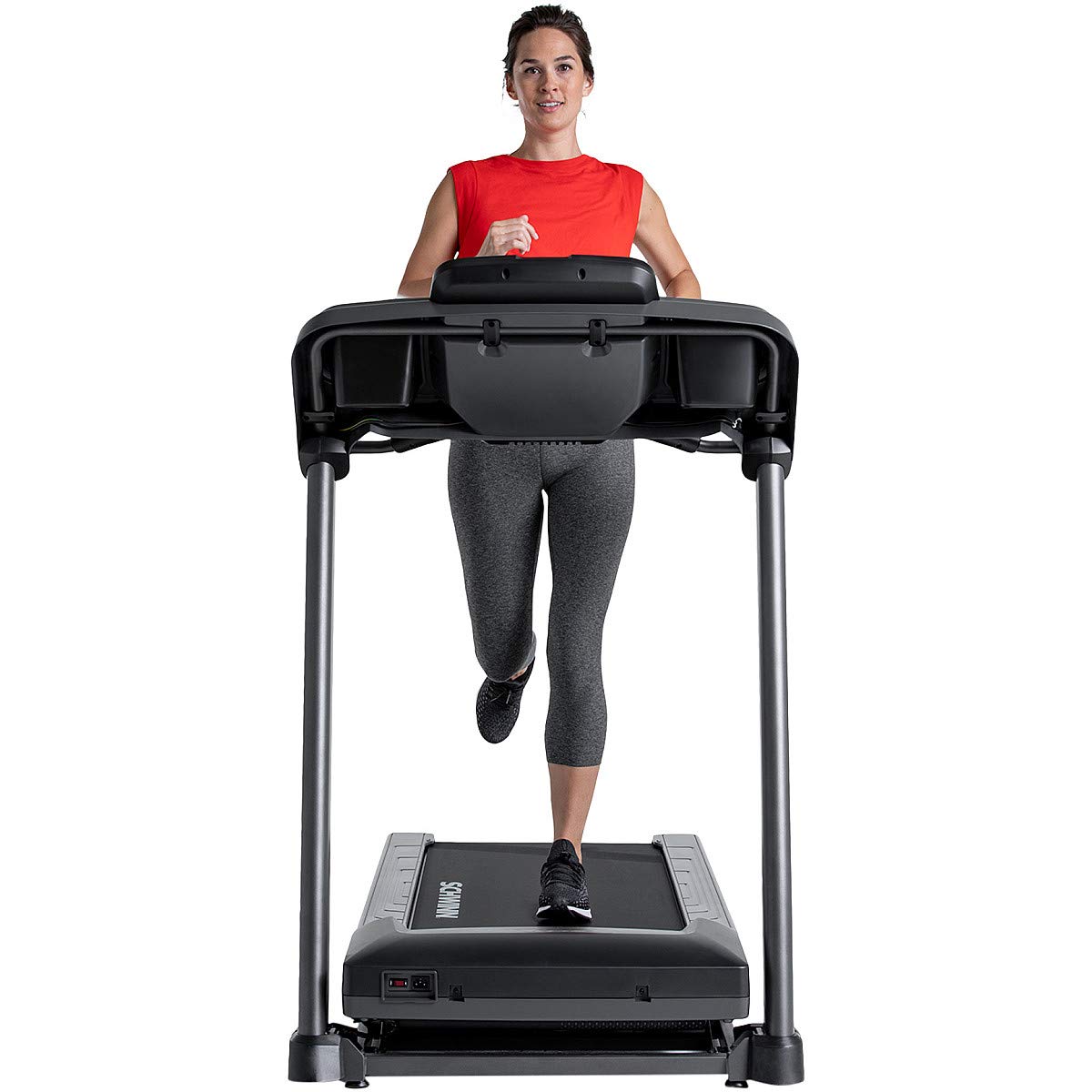 Woman running on a treadmill with a white background