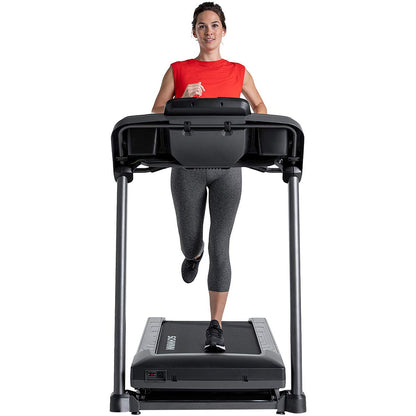 Woman running on a treadmill with a white background