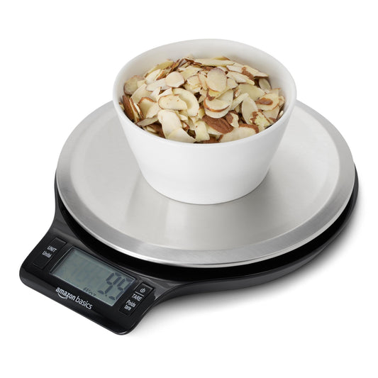 Digital kitchen scale with a bowl of almonds on a white background