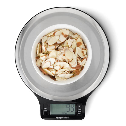 Digital kitchen scale with a bowl of almonds on a white background