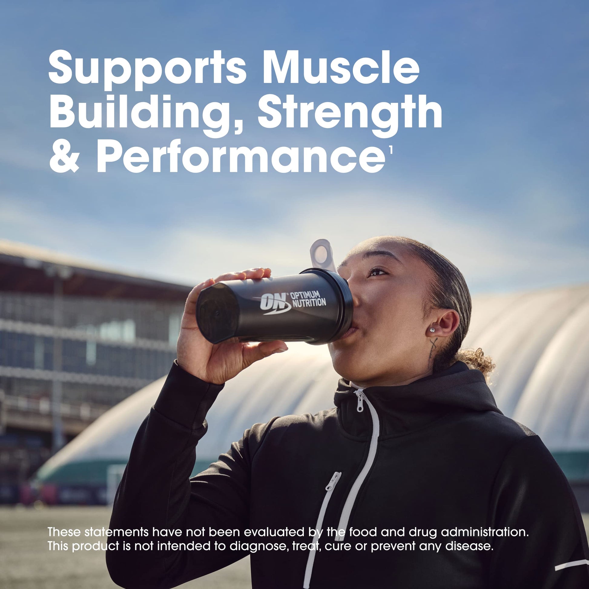 Person drinking from a Dymatize Nutrition shaker bottle with text about muscle building, strength, and performance.