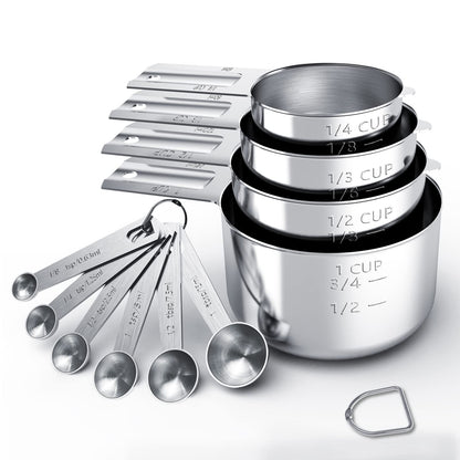 Set of stainless steel measuring cups and spoons on a white background