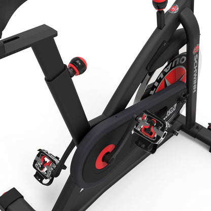 Close-up of a black and red exercise bike on a white background