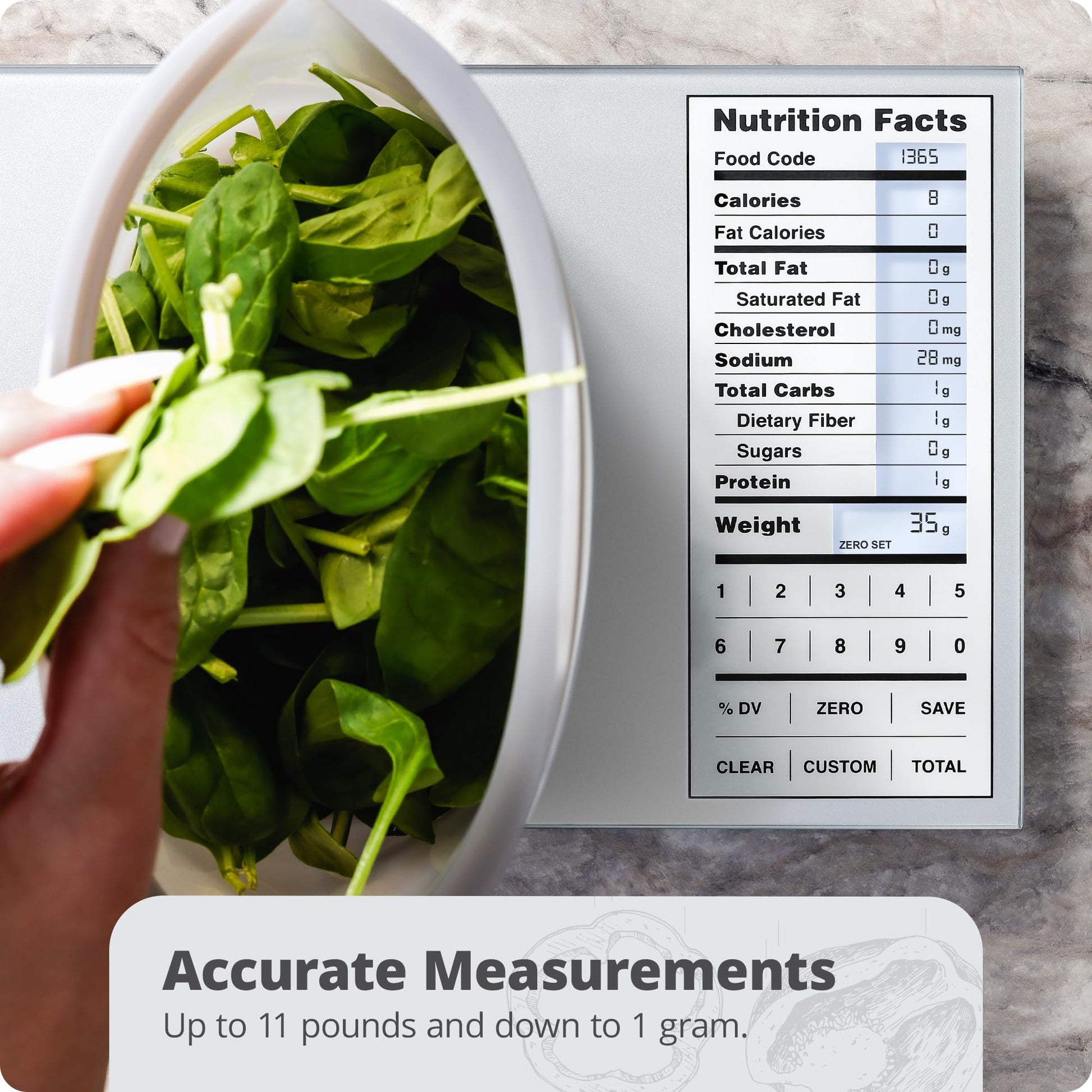 Digital scale with a bowl of spinach and nutrition facts display on a marble surface.