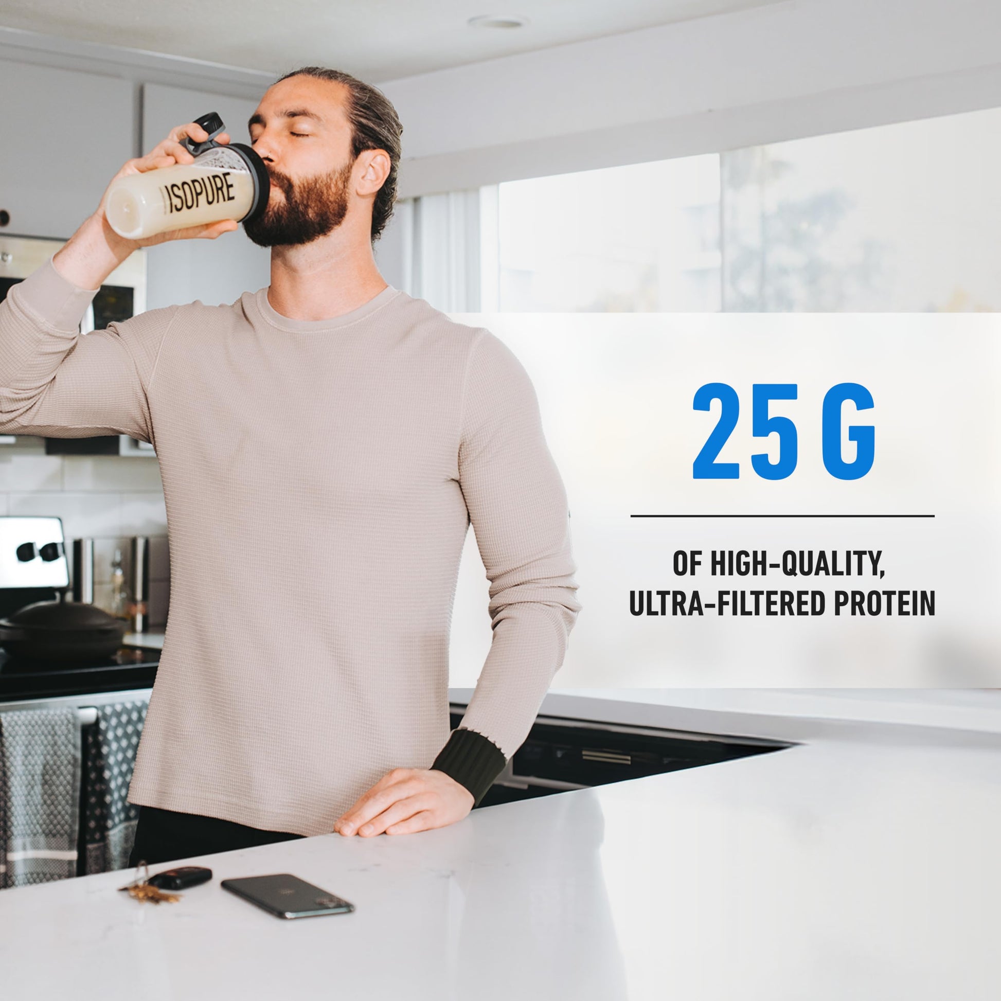Man drinking from a protein shake container with text about protein content in a kitchen setting