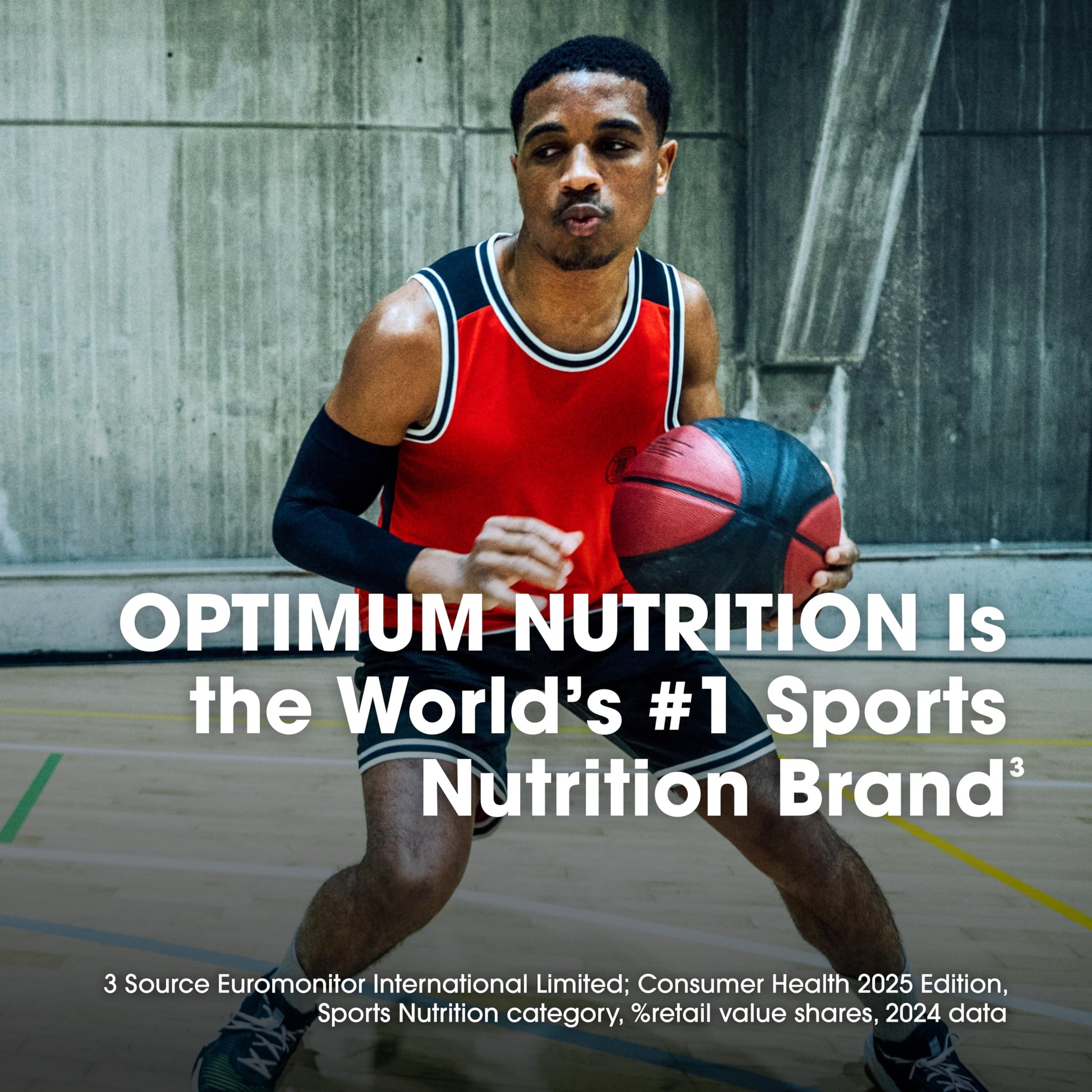 Man holding a basketball on a court with Optimum Nutrition branding text.