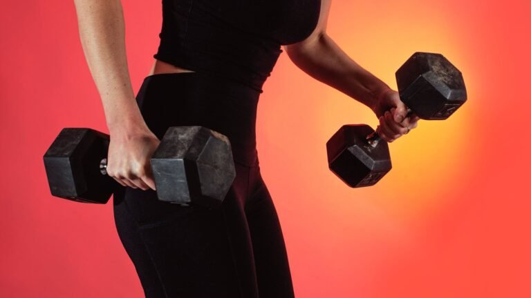 Woman lifting dumbbells during strength training workout