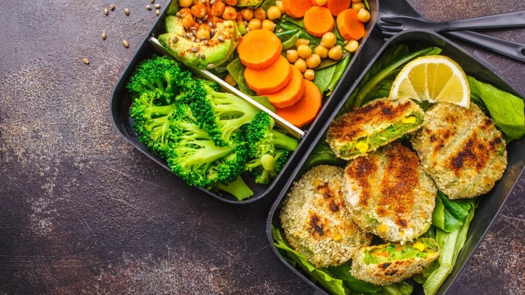 Healthy pre-packaged meal with vegetables, chickpeas, and plant-based patties