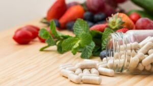 Dietary supplement capsules with fresh fruits and herbs representing natural health solutions