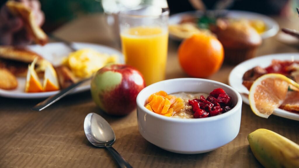 Healthy breakfast with oatmeal, fruit, and juice for balanced nutrition and weight loss
