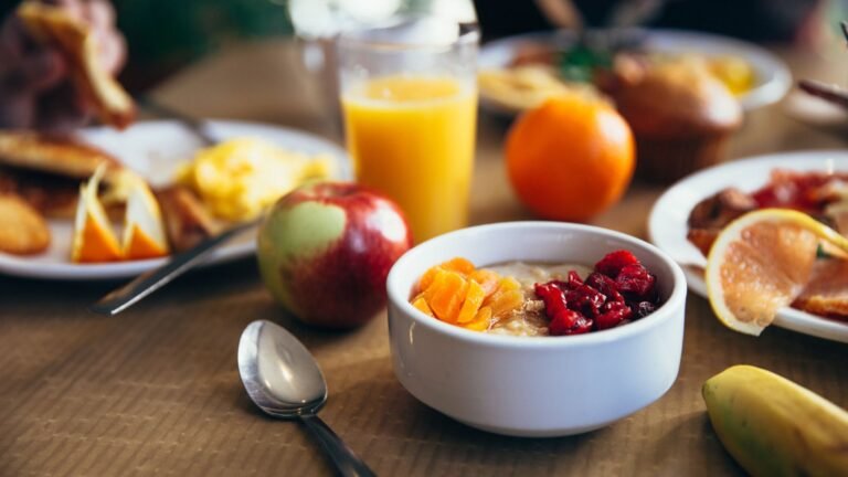 Healthy breakfast with oatmeal, fruit, and juice for balanced nutrition and weight loss
