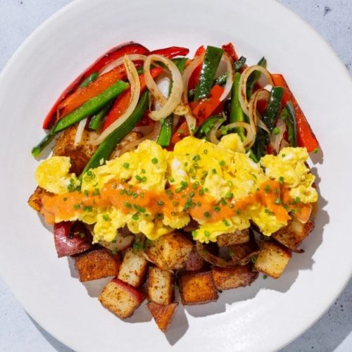 Trifecta breakfast plate with scrambled eggs, roasted potatoes, and grilled vegetables