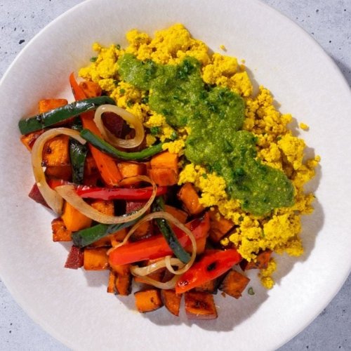 Trifecta vegan breakfast with tofu scramble, sweet potatoes, and sautéed vegetables