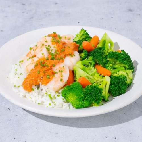 Trifecta shrimp with rice, broccoli, and carrots topped with clean sauce