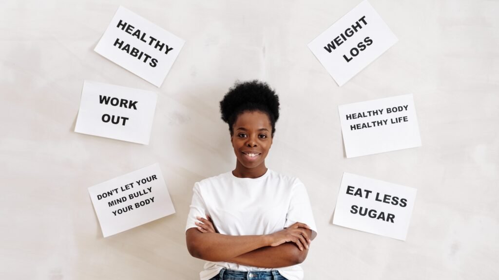 Smiling woman surrounded by motivational health and fitness messages about weight loss and healthy habits