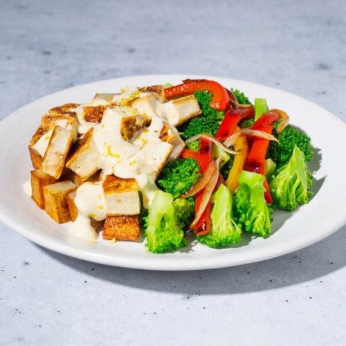 Trifecta vegan tofu meal with broccoli, red peppers, and creamy sauce
