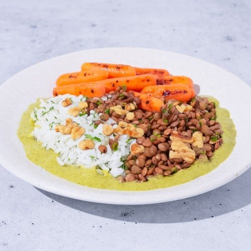 Trifecta vegan lentil bowl with rice, roasted carrots, and creamy green sauce
