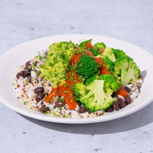 Trifecta vegan bowl with broccoli, quinoa, black beans, guacamole, and red sauce