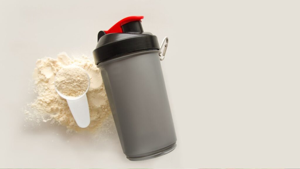 Protein shaker bottle with a scoop of protein powder