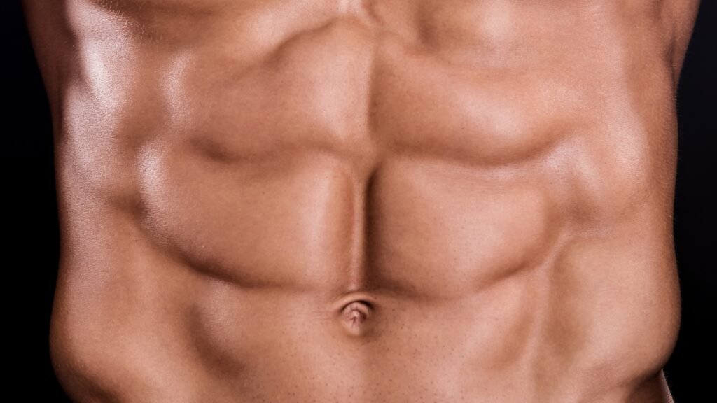 Defined abdominal muscles showing the results of consistent core training and proper fitness methods Close-up of toned abdominal muscles symbolizing fitness and core strength