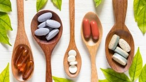 Various dietary supplements in wooden spoons for evidence-based weight loss support